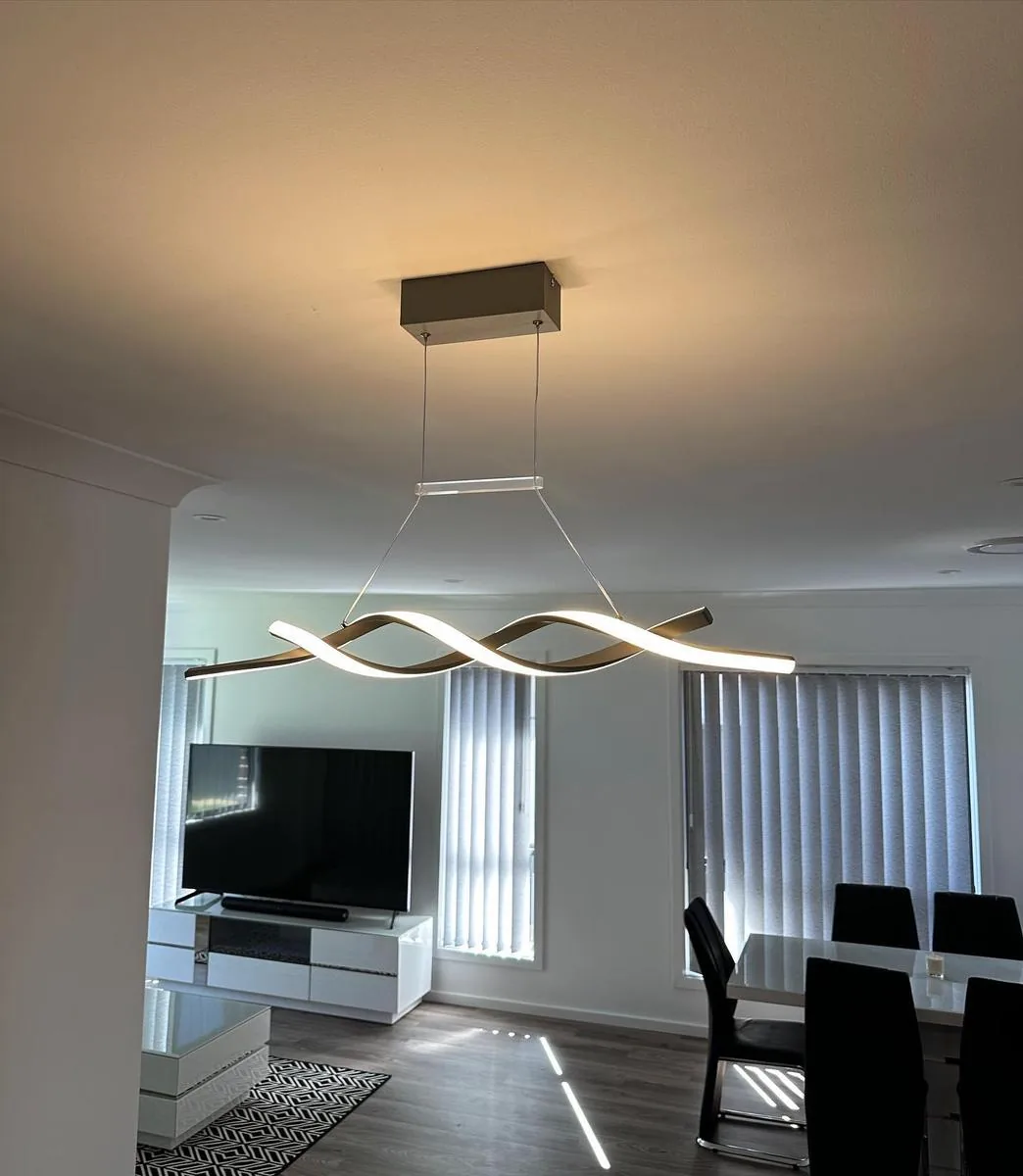 Modern feature pendant light installed above living and dining area