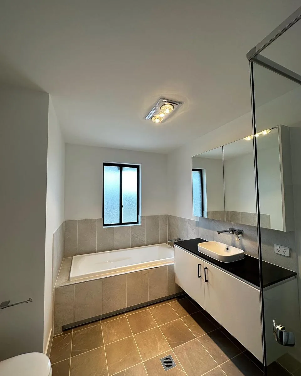 Modern bathroom with ceiling light and vanity lighting