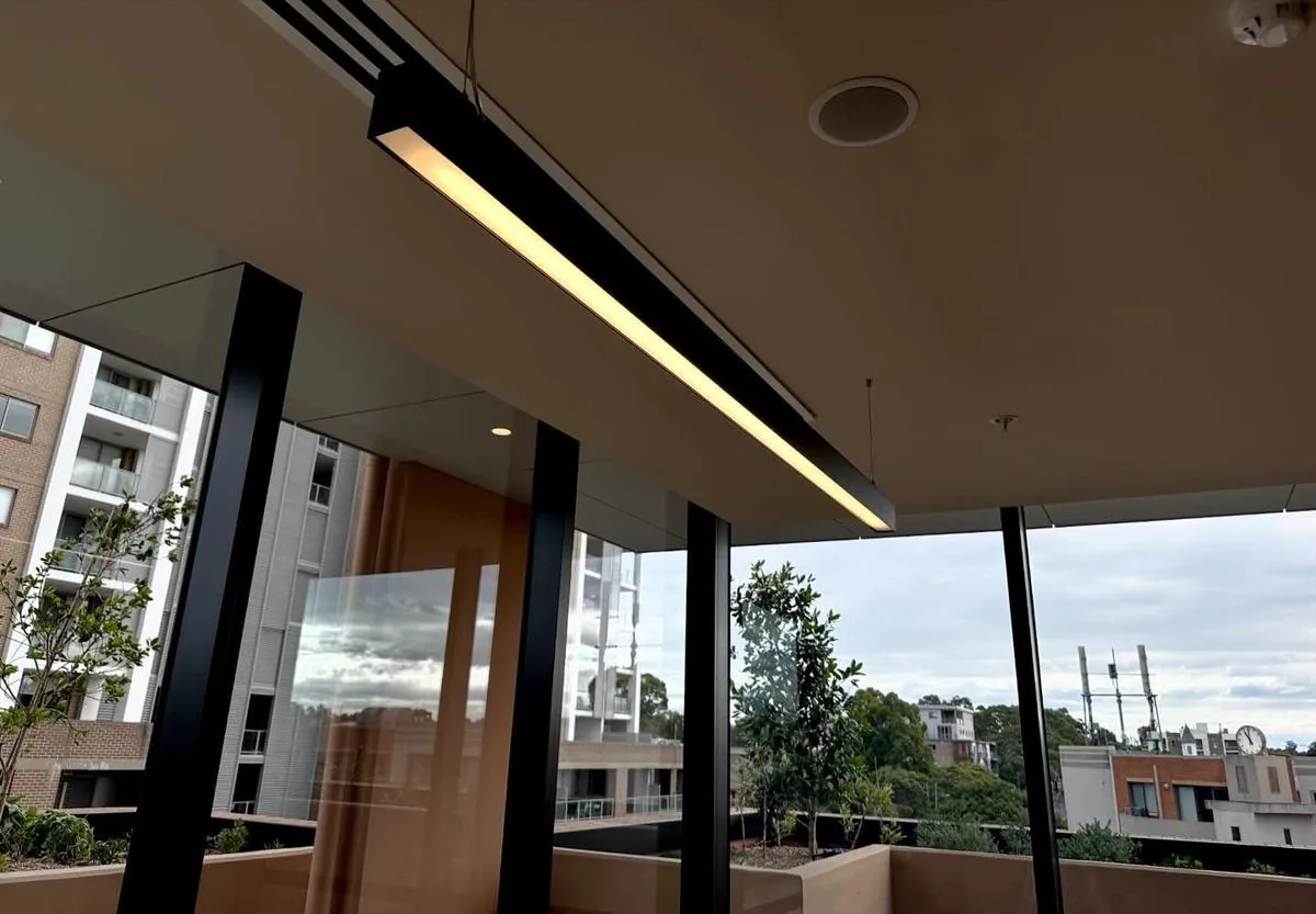 Linear pendant light installed in a commercial setting with large windows