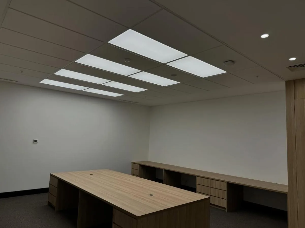 Office room with modern ceiling panel lighting