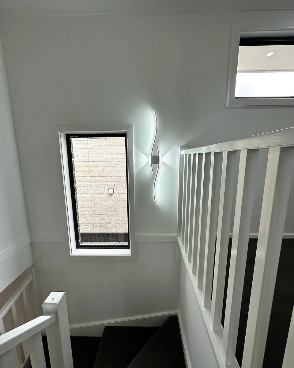 Modern stairwell with decorative wall light and clean interior finish